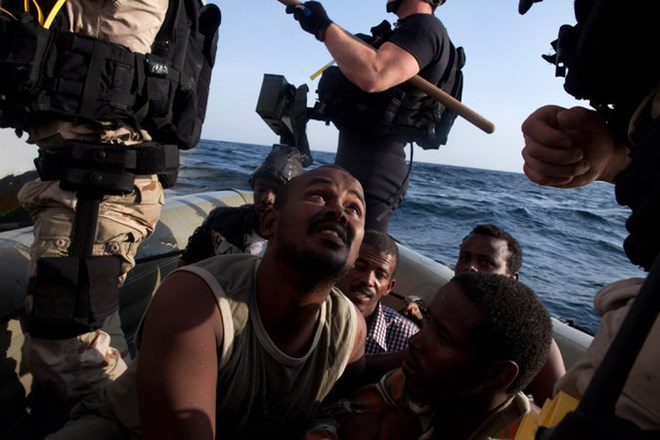 American sailors took Somali pirates from a fishing vessel where they were captured in 2012 to a small Navy craft to be transported for processing.